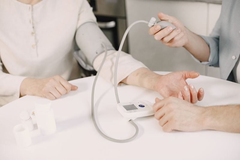 Healthcare worker measuring blood pressure in a clinical setting