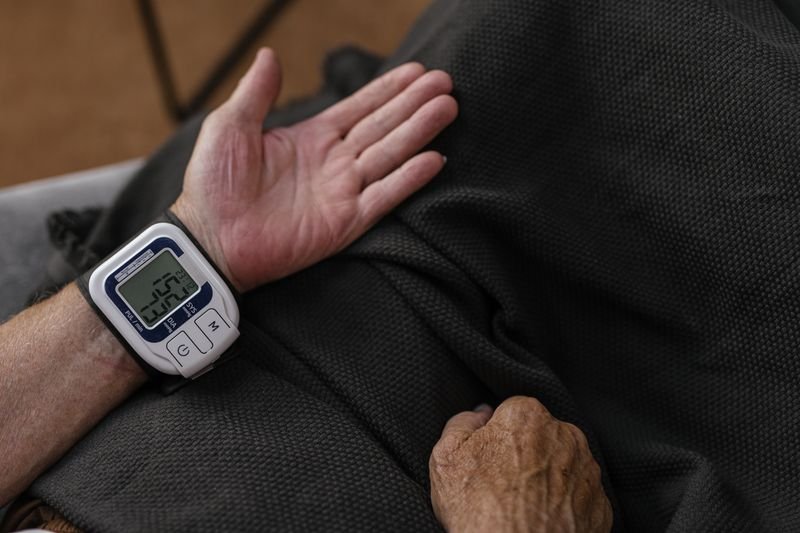 Person using a wrist blood pressure monitor